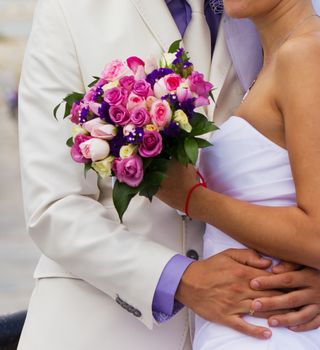 Bride and groom on their wedding day hugging.