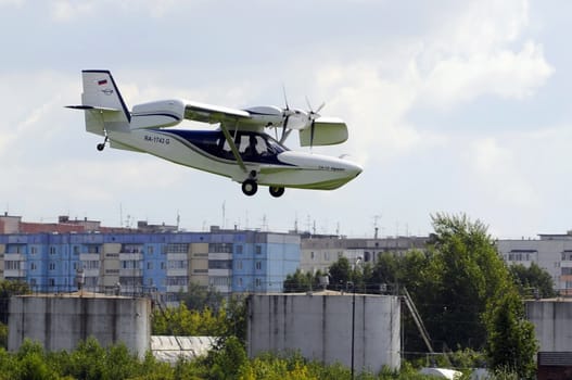 The Orion SK-12 amphibian in flight over the city