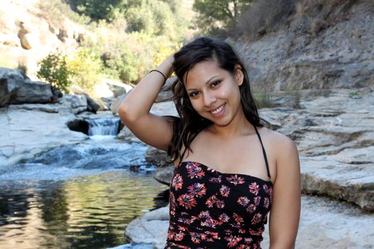 Young Hispanic woman near a creek.