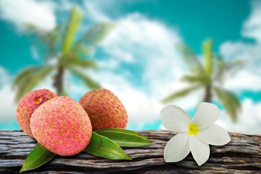 Lychee and flowers with  coconut and sky blur on background