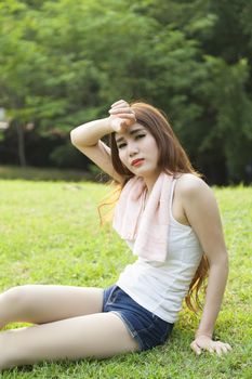 Woman sitting rest after exercise Inside the park