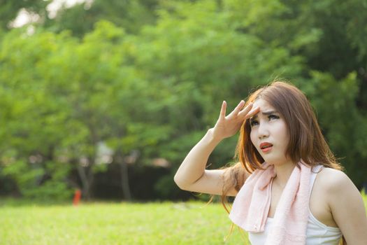 Woman sitting rest after exercise Inside the park