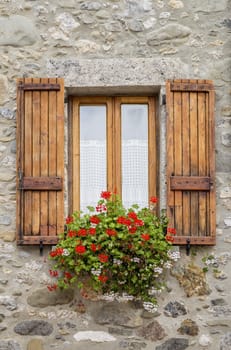 Picture of a wooden window with stone walls.