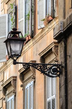 Lantern on wall, old streets of Rome, Italy