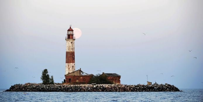 Moon and Old lighthouse of the Suho  island in Ladoga.