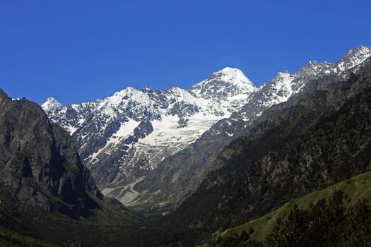 Caucasus mountains under snow and clear blue sky