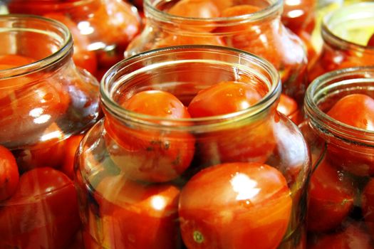 Tasty tomatoes ready to canned in glass jar