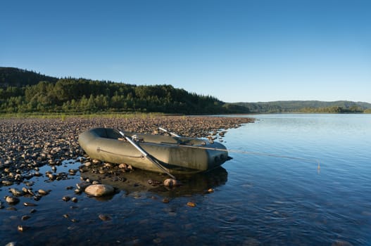 Inflatable boat and spinning on the river