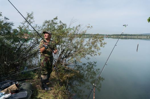 Fishing on the lake fisherman throws a spinning