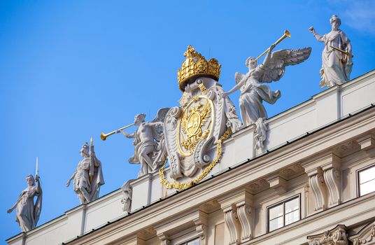 VIENNA, AUSTRIA - AUGUST 4, 2013: Architectural artistic emblem decoration symbol of Imperial Chancellory Wing (Reichskanzleitrakt ) on Hofburg palace, Vienna, Austria.