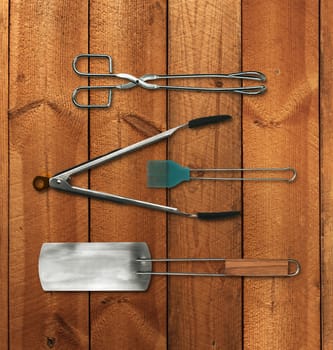 Barbeque tools set on brown plank wood background