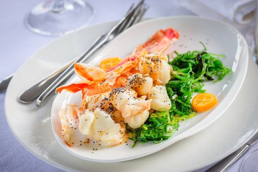 Prepared lobster and sea weed served on plates