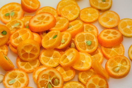 tray full of ripe kumquat slices, suitable as background