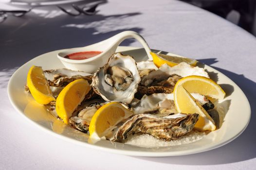 plate of oysters with lemon and special sauce