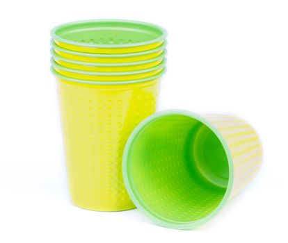 Yellow and Green Disposable Plastic Cups isolated on white background