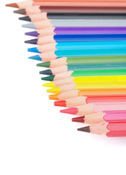 Slanted Border of Multicolored Pencils isolated on white background. Focus on Foreground
