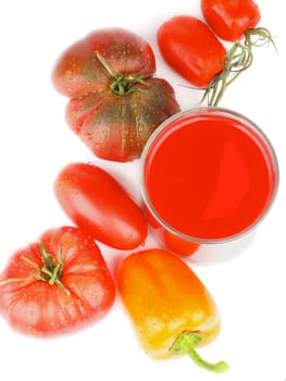 Freshly Squeezed Tomato Juice with Various Tomatoes and Orange Bell Pepper closeup on White background. Top View