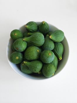 White bowl of green figs