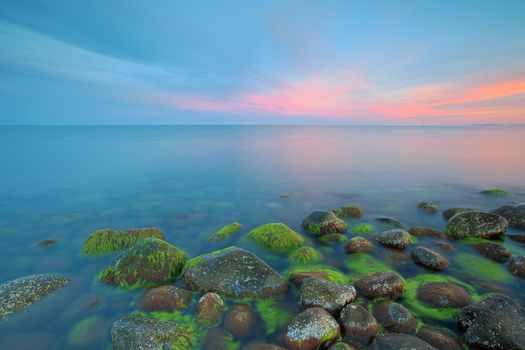 Sunset over the rolling stones of the Norwegian coast, Moelen