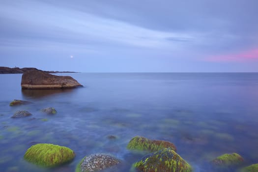 Sunset over the rolling stones of the Norwegian coast, Moelen