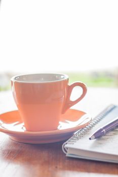 Cup of coffee with pen and notebook, stock photo