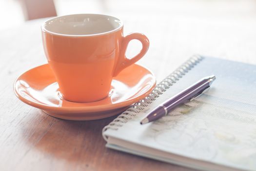 Cup of coffee with pen and spiral notebook, stock photo