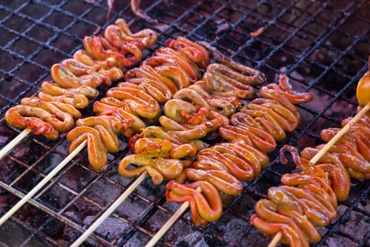 grilled mild intestinal of chicken with heat  on a grill