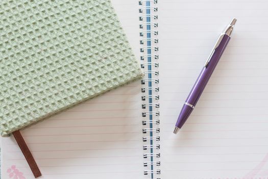 Top view of green notebook, pen and spiral notebook, stock photo