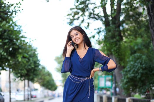 Young beautiful woman talking on cell phone