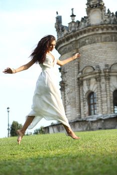 Sexy woman in a white dress on a background of the church