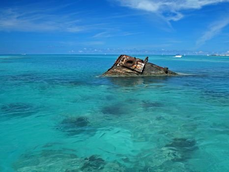 One end of a ship wreck (the Vixen) emerging from a tropical Sea