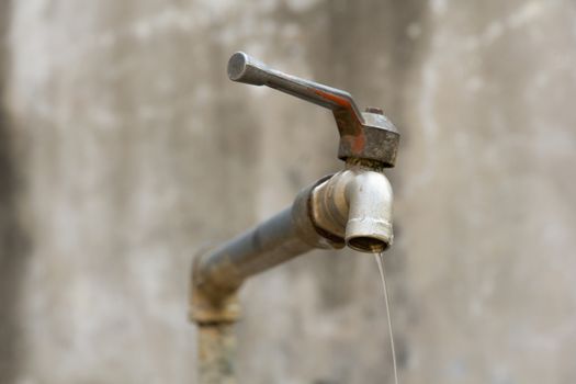 a dripping tap showing water being wasted