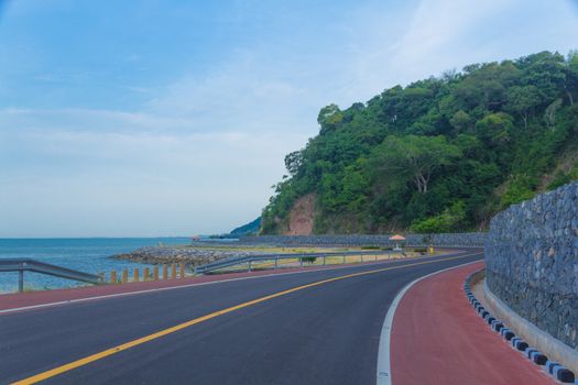 road in the mountains turns sharply over the mountain leading to the sea