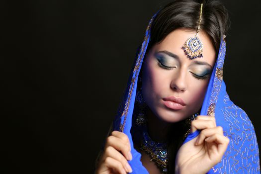 Young beautiful brunette woman in indian blue dress