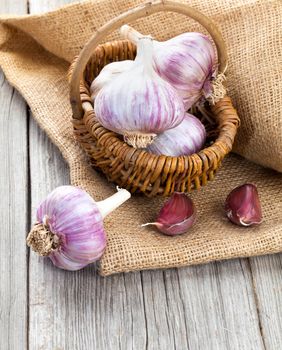 garlic on Burlap sack, on wooden background
