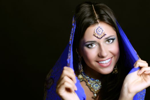 Young beautiful brunette woman in indian blue dress