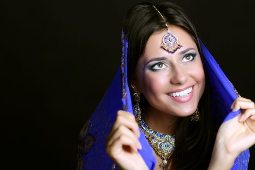 Young beautiful brunette woman in indian blue dress