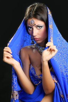 Young beautiful brunette woman in indian blue dress