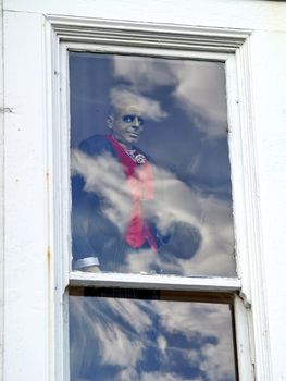 Smiling zombie behind a window