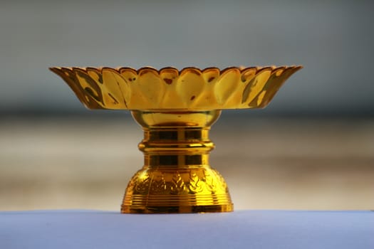 The tray with pedestal.It has gold colour.