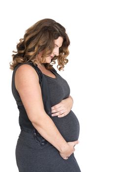 pregnant woman holding her hands on her belly 