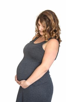 pregnant woman holding her hands on her belly in heart shape