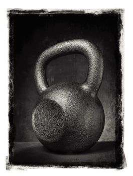 Grunge photo of a rough and heavy kettlebell.