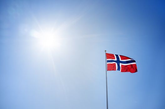 The flag of Norway agains sunny sky.
