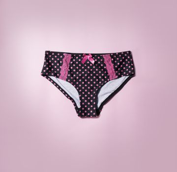 Polka dot panties on pink background.