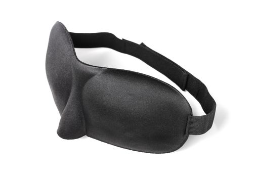 A Comfortable black sleep mask made of neoprene isolated on white with natural shadows.