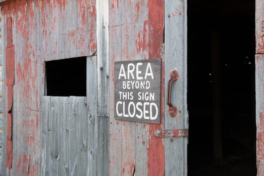 A sign reading “Area Beyond This Sign Closed” on an abandoned barn in the Arapaho National Wildlife Refuge.