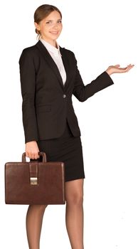 Businesswoman holding a briefcase and shows his hand towards. Isolated on white background