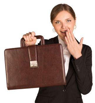 Businesswoman shows the briefcase and covers her mouth with joy. Isolated on white background