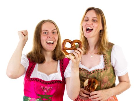 Women in dirndl eating delicious pretzel